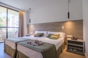 a bedroom with a large bed and a large window at Estival Islantilla in Islantilla