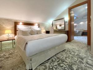 a hotel room with a large bed and a mirror at Penthouse Apartment in Hotel Eney in Lviv