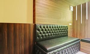 a leather seat in a booth in a room at Itsy By Treebo - Sapphire Residency in Manjeri