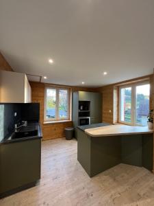 a kitchen with a large island in a room at Chez Léa et Lolo - Le Nordique in Gérardmer
