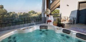 a jacuzzi tub on the balcony of a house at 4 Elements צימר ארבעת היסודות in Rosh Pinna