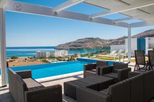 a villa with a swimming pool and a view of the ocean at Blue Horizon 2 in Líndos