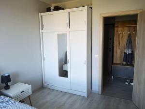 a bedroom with a bed and a white closet at Apartment Opalchenska / Pirotska in Sofia