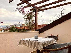 a table and chairs on a balcony with a view of a building at Ten Apart Hotel in Fethiye