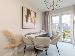 a dining room with a table and chairs and a window at Pass the Keys Stylish 2BR House in Leafy Warfield with Garden in Bracknell