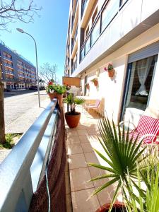 un balcone di un edificio con piante in vaso di Zenit Luxury Marina Village Appartement a Olhão