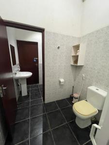 a bathroom with a toilet and a sink at Reef Bungalow Hotel in Pamunugama