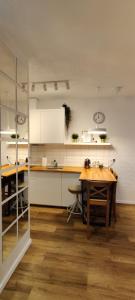 a kitchen with a wooden table and white cabinets at Zebra in Wrocław