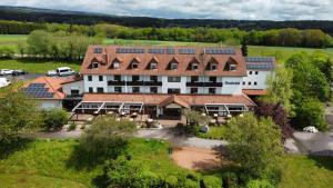 an aerial view of a building with solar panels on it at Seehotel Losheim in Losheim