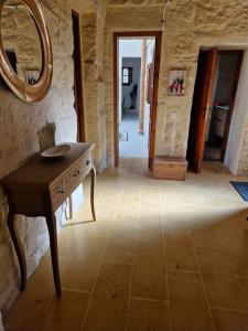 a room with a table and a mirror on the wall at Cozy 1 Bedroom House in Iz-Zejtun in Żejtun