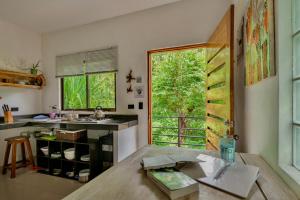 a kitchen with a table and a large window at Tamarindo Sunshine in Tamarindo