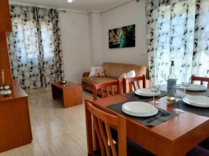 uma sala de jantar e sala de estar com mesa e cadeiras em ACV - Costa Caribe II-2ª linea, planta 6, frontal em Oropesa del Mar