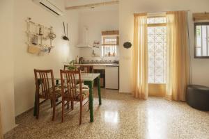 a kitchen with a table and chairs and a window at APARTAMENTO CAMINO MOZARABE in Baena +9 photos