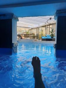 a person laying in the water in a swimming pool at Colours - a sweet complex in a fairytale setting in Ix-Xgħajriet