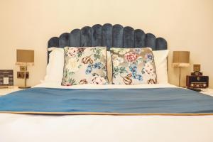 un letto con due cuscini e una grande testiera di The Royal Kings Arms a Lancaster