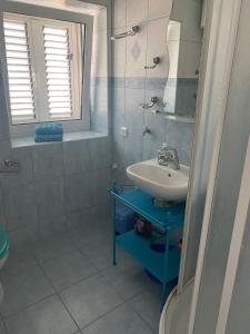 a bathroom with a sink and a mirror at Apartments Tereza in Milna