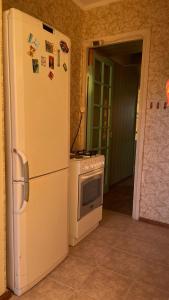 a kitchen with a refrigerator and a stove at Квартира в Агудзере in Agudzera