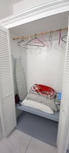 a closet with a shelf with a pillow on it at Cozy vacation retreat with free parking in Roseau