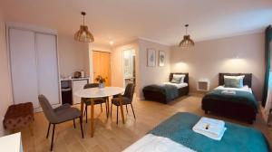 a bedroom with two beds and a table and a room at Metalowiec in Stalowa Wola