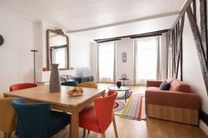 a living room with a table and chairs at 123paris city in Paris