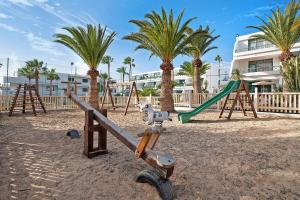 a playground with a swing set and a slide at Casa Joyne in Puerto del Carmen