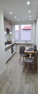 a kitchen with a table and chairs in a room at Apartament Busko-Zdrój - Franio in Busko-Zdrój