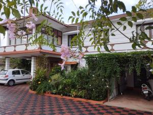 a building with a car parked in front of it at Sabaoth Stays, in Madikeri