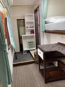 a bedroom with a bunk bed and a desk in a room at GreenHotel in Tokyo