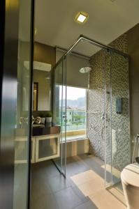 a bathroom with a glass shower and a toilet at Bungalow cheras hijauan residence HomeStay 6 bedrooms in Cheras