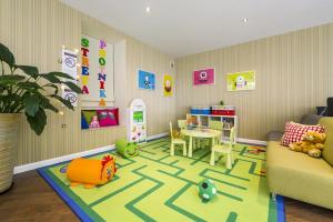 a living room with a childs room with a table and toys at Hotel Patio Old Town in Wrocław