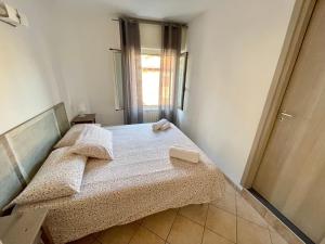 A bed or beds in a room at Borgo Antico Apartments