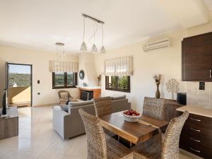 a living room with a table and a couch at Villa Hibiscus in Spiliá