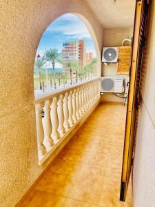 a room with a view of the beach through a window at Bungalow en Arenales del Sol in Arenales del Sol