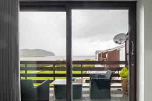 a view of a patio with a table and chairs at Rivage - Modern Maisonette in Deganwy