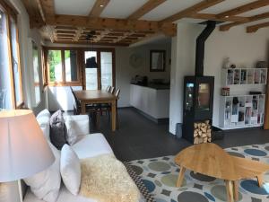 a living room with a white couch and a fireplace at Chasa Tusa 2 in Scuol