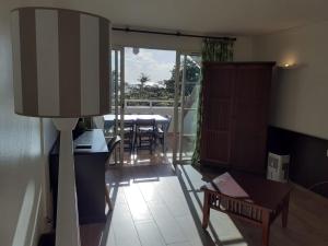 a living room with a table and a dining room at Appartements village Pierre et Vacances vue mer Aouara Roucou Malaka Guadeloupe St Anne in Sainte-Anne