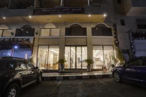a store front with cars parked in front of it at mass paradise2 in Aqaba