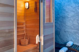 a sauna with a wooden wall and a door at Agio Comfy Place in Civitanova Marche