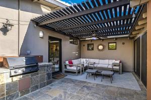 a patio with a grill and a table and chairs at Movie Colony East Eden Permit# 3625 in Palm Springs