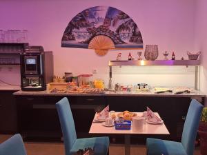 a table with chairs and a table with food on it at Gästehaus Alpina in Berchtesgaden +32 photos