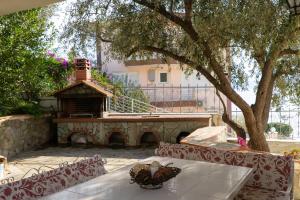 a patio with a table and a bird house at Villa Seaside View in Volos