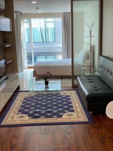 a living room with a bed and a couch at Studio Bedroom with Kitchen in Bangkok