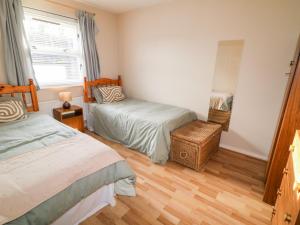 a bedroom with two beds and a window at 17 Buninver Road in Omagh