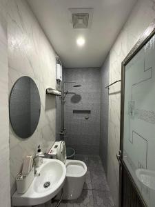 a bathroom with a sink and a toilet and a mirror at Clark pampanga( dale’s crib) in Mabalacat