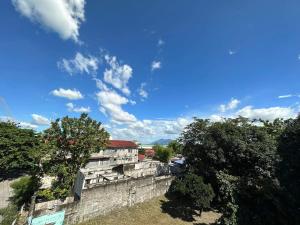 a blue sky with clouds above a stone wall at Clark pampanga( dale’s crib) in Mabalacat