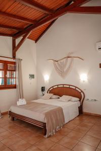 a bedroom with a large bed in a room at Residence AU 'TI SUCRIER in Deshaies