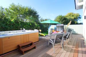 un patio con una mesa y una sombrilla en una terraza en Ferienhaus Vejle, en Steinbergkirche