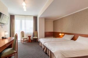 Postel nebo postele na pokoji v ubytování Vestina Wellness & SPA Hotel