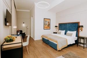 a hotel room with a bed and a desk at Artist hotel in Subotica