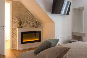 a bedroom with a fireplace in a room at Zia Maria in Fasano